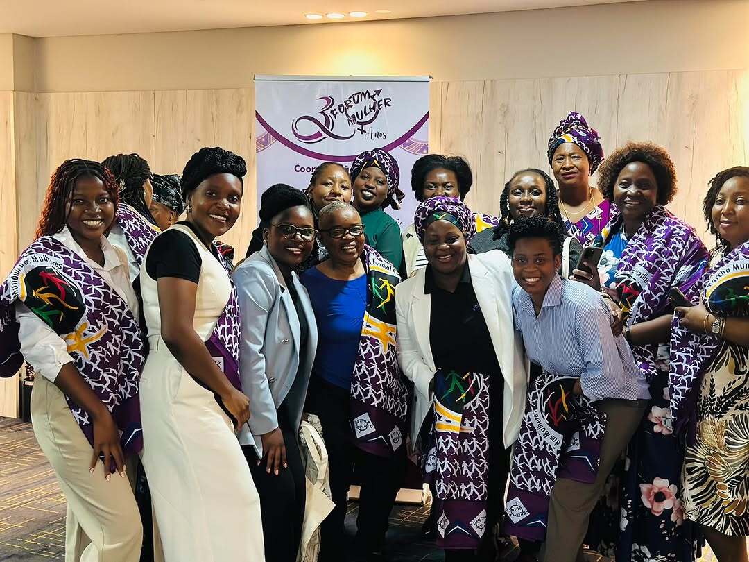 Mozambique women gathered around smiling at the camera